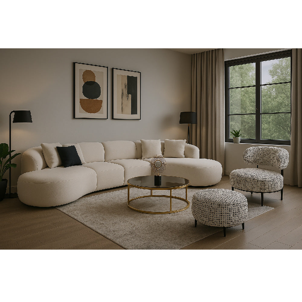 Modern comfort living room with a curved beige sofa and patterned chairs.

